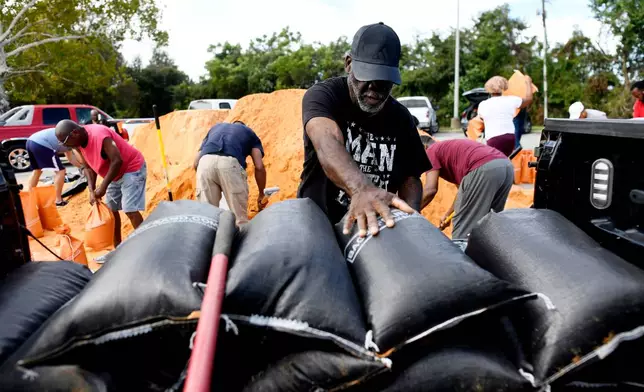 Residents pick up sandbags for storm preparation at the James Seals Jr. Parks & Recreation Center ahead of Hurricane Isaias' expected landfall along the Gulf Coast, Thursday, Oct. 8, 2026, in Mobile, Ala. (AP Photo/Octavio Jones)