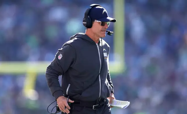 Los Angeles Chargers head coach Jim Harbaugh watches from the sideline during the first half of an NFL football game against the Seattle Seahawks, Sunday, Oct. 4, 2026, in Seattle. (AP Photo/Kevin Ng)