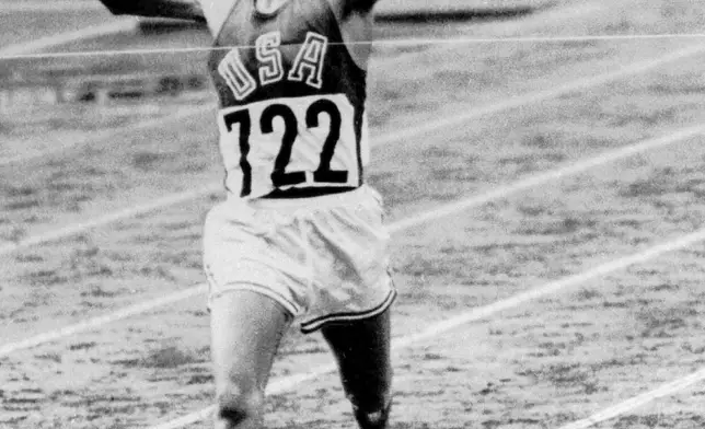 FILE - U.S. Marine Lt. Billy Mills breaks the tape to win the 10,000-meter race, setting an Olympic record, on Oct. 14, 1964, in Tokyo. (AP Photo, File)