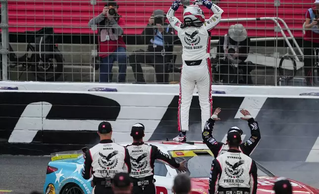 Chase Briscoe and his team celebrate after winning a NASCAR Cup Series auto race, Sunday, Oct. 11, 2026, in Concord, N.C. (AP Photo/Matt Kelley)