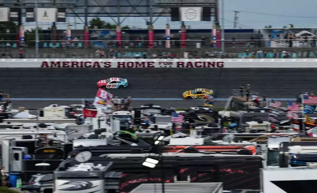 Chase Briscoe (19) and Christopher Bell (20) compete through Turn 3 during a NASCAR Cup Series auto race, Sunday, Oct. 11, 2026, in Concord, N.C. (AP Photo/Matt Kelley)