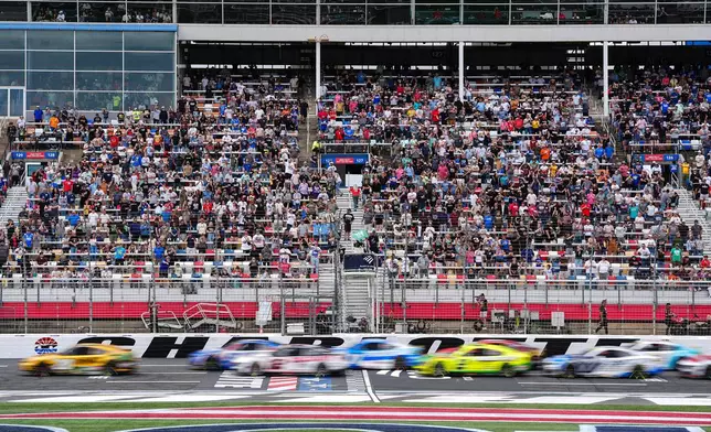 A pack of cars come to a green flag restart during a NASCAR Cup Series auto race, Sunday, Oct. 11, 2026, in Concord, N.C. (AP Photo/Matt Kelley)