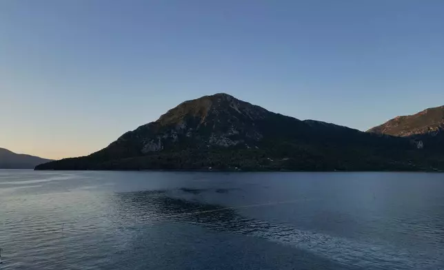The island of Kalamos is seen from Mytikas, the nearest mainland town, in western Greece, early Thursday, Sept. 24, 2026. (AP Photo/Petros Giannakouris)