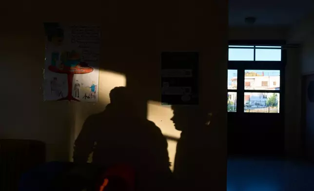 A high school student waits for classes to begin at a school in the mainland town of Mytikas, western Greece, Thursday, Sept. 24, 2026. (AP Photo/Petros Giannakouris)