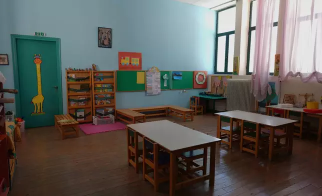 An empty classroom is seen at a kindergarten that has remained closed for a second consecutive school year because of a lack of students on the island of Kalamos in the Ionian Sea, western Greece, Wednesday, Sept. 23, 2026. (AP Photo/Petros Giannakouris)