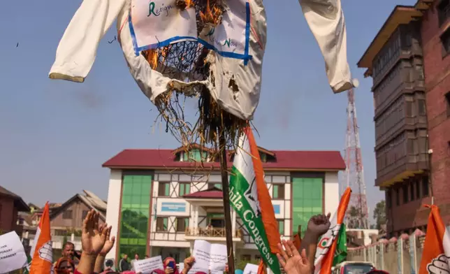 India's opposition Congress party workers burn an effigy of India's election chief Gyanesh Kumar during a protest in Srinagar, Indian controlled Kashmir, Saturday, Oct. 17, 2026. The Congress party workers were demanding the resignation of Kumar as well as protesting against an administrative officer who allegedly abused a female colleague during a virtual meeting. (AP Photo/Dar Yasin)