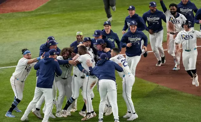 The Tampa Bay Rays celebrate their win after the 12th inning of Game 4 of baseball's World Series, Wednesday, Oct. 28, 2026, in St. Petersburg, Fla., between the Milwaukee Brewers and the Tampa Bay Rays. (AP Photo/Morry Gash)