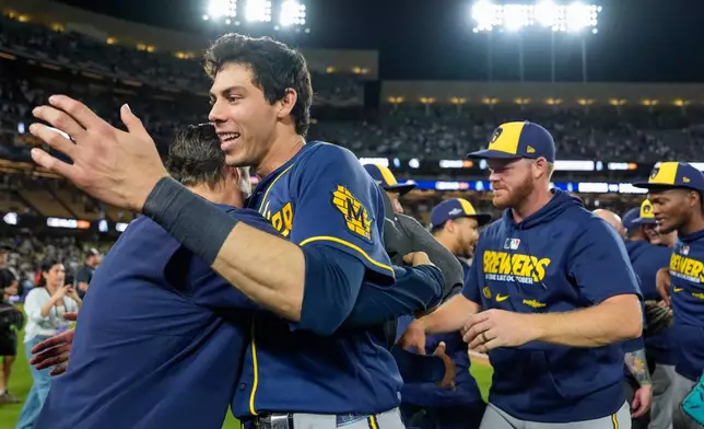 Milwaukee Brewers designated hitter Christian Yelich celebrates with teammates after Game 4 of baseball's National League Championship Series between the Milwaukee Brewers and the Los Angeles Dodgers, Thursday, Oct. 15, 2026, in Los Angeles. (AP Photo/Ashley Landis)
