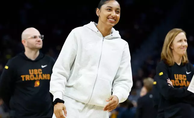 FILE - USC guard Juju Watkins (12) looks on from the sideline before the game against California during an NCAA basketball game on Dec. 21, 2025, in San Francisco. (AP Photo/Lachlan Cunningham, File)
