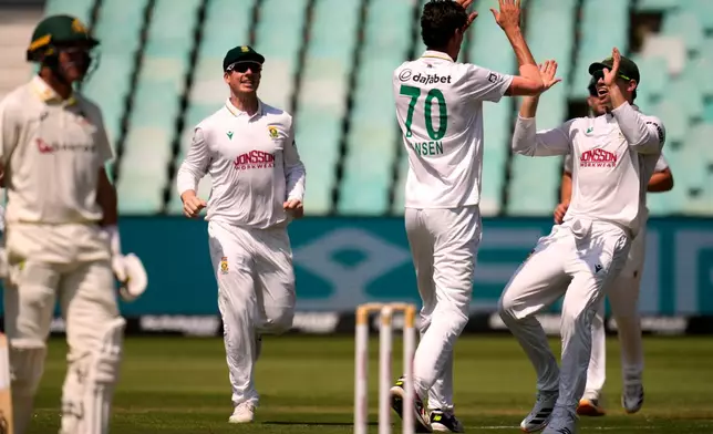 South Africa's Tristan Stubbs, right, celebrates with his teammate Marco Jansen for bowling out Australia's Nic Maddinson on day one of the first cricket test match between South Africa and Australia, in Durban, South Africa, Friday, Oct. 9, 2026. (AP Photo/Themba Hadebe)
