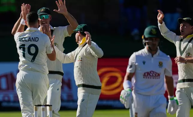 Australia's Scott Boland, left, celebrates the wicket of South Africa's Marques Ackerman on day two of the second cricket test match between South Africa and Australia, in Gqeberha, South Africa, Monday, Oct. 19, 2026. (AP Photo/Themba Hadebe)