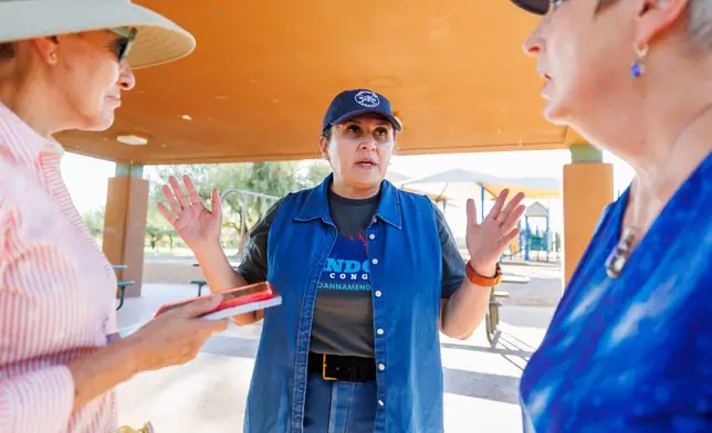 JoAnna Mendoza (D), an Arizona Congressional District 6 candidate, center, talks with campaign volunteers before a weekly neighborhood canvass, Thursday, Oct. 15, 2026, in Oro Valley, Ariz. (AP Photo/Mike Christy)