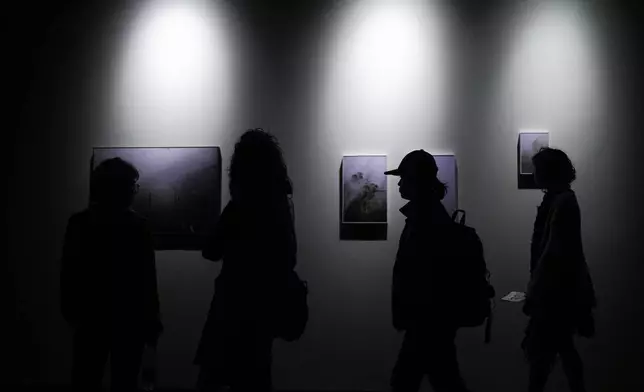 Visitors tour the international art fair ARTBO in Bogota, Colombia, Thursday, Sept. 24, 2026. (AP Photo/Ivan Valencia)