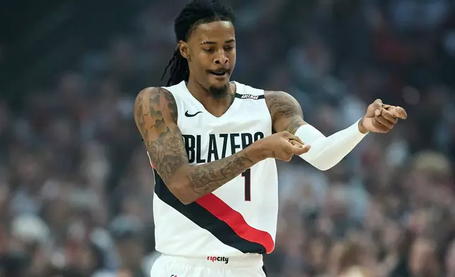 Portland Trail Blazers guard Ja Morant reacts after making a 3-point basket against the Phoenix Suns during the first half of an NBA basketball game in Portland, Ore., Wednesday, Oct. 21, 2026. (AP Photo/Craig Mitchelldyer)