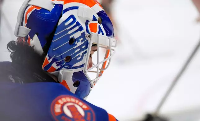 Edmonton Oilers goaltender Devon Levi takes a break during a timeout in the second period of an NHL hockey game against the Anaheim Ducks, Wednesday, Oct. 7, 2026, in Anaheim, Calif. (AP Photo/Mark J. Terrill)