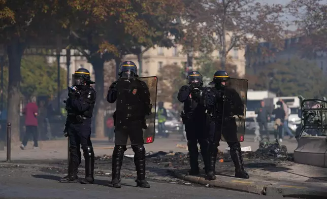 Policemen face students during a protest against under-resourced schools, in Paris, Friday, Oct. 2, 2026. (AP Photo/Aurelien Morissard)