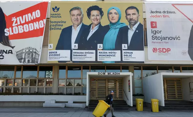 A man walks beneath an election poster featuring People and Justice Party (NiP) candidates for the upcoming general elections in Sarajevo, Bosnia, on Sept. 29, 2026. (AP Photo/Armin Durgut)