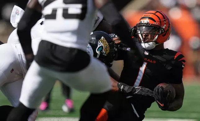 Cincinnati Bengals wide receiver Ja'marr Chase (1) is tackled during an NFL football game against the Jacksonville Jaguars in Cincinnati, Sunday, Oct. 4, 2026. (AP Photo/Joshua A. Bickel)