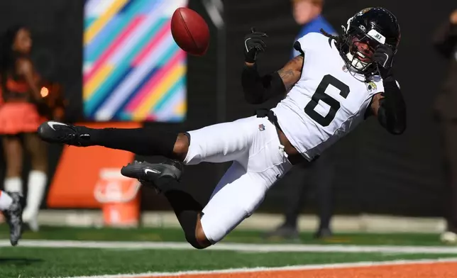 Jacksonville Jaguars safety Antonio Johnson (6) throws back a punt during an NFL football game against the Cincinnati Bengals in Cincinnati, Sunday, Oct. 4, 2026. (AP Photo/Tanner Pearson)