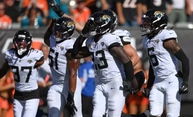 Jacksonville Jaguars defensive tackle Matt Dickerson (93) celebrates an interception during an NFL football game against the Cincinnati Bengals in Cincinnati, Sunday, Oct. 4, 2026. (AP Photo/Tanner Pearson)