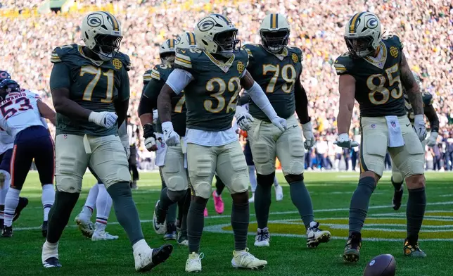 Green Bay Packers' Marshawn Lloyd celebrates his touchdown run during the first half of an NFL football game against the Chicago Bears in Green Bay, Wis., Sunday, Oct. 11, 2026. (AP Photo/Nam Huh)