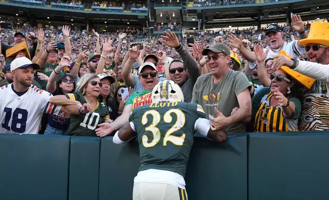 Green Bay Packers' Marshawn Lloyd celebrates his touchdown run with fans during the first half of an NFL football game against the Chicago Bears in Green Bay, Wis., Sunday, Oct. 11, 2026. (AP Photo/Nam Huh)