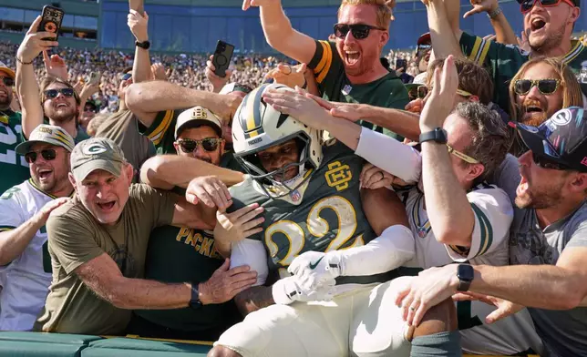 Green Bay Packers' Marshawn Lloyd celebrates his touchdown run with fans during the second half of an NFL football game against the Chicago Bears in Green Bay, Wis., Sunday, Oct. 11, 2026. (AP Photo/Mike Roemer)