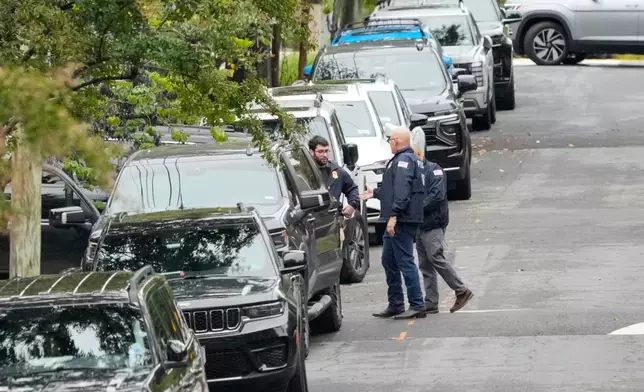 Homeland Security officers stand on 26th Street NE in Washington, early Monday, Oct. 12, 2026, during an investigation at the residence of Rep. Ilhan Omar, D-Minn. (AP Photo/J. Scott Applewhite)