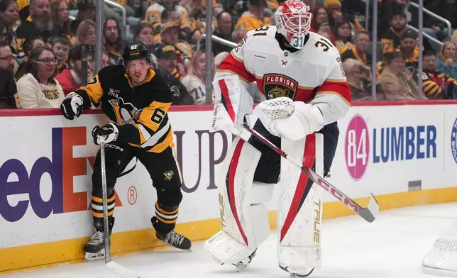 Florida Panthers goalie Cooper Black (31) clears the puck in front of Pittsburgh Penguins' Rickard Rakell (67) during the second period of an NHL hockey game in Pittsburgh, Thursday, Oct. 22, 2026. (AP Photo/Gene J. Puskar)