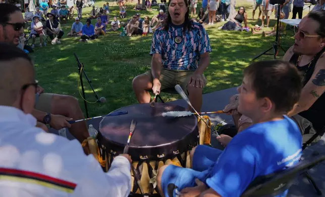 Members of a Penobscot drum circle perform at the Dawnland Festival held at the College of the Atlantic in Bar Harbor, Maine, on Saturday, July 11, 2026. (AP Photo/Jessie Wardarski)