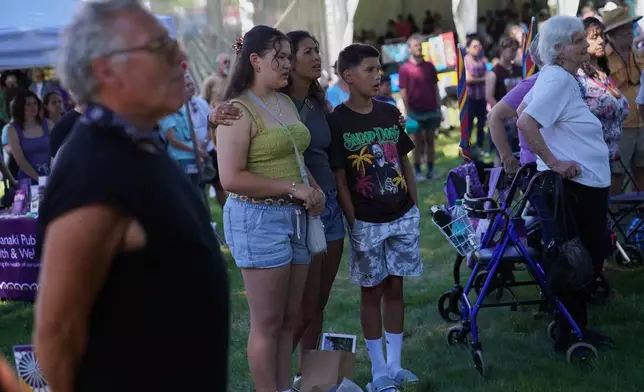 A family sings with a drum circle at the Dawnland Festival of Arts and Ideas, hosted by the Abbe Museum, at the College of the Atlantic in Bar Harbor, Maine, on Saturday, July 11, 2026. (AP Photo/Jessie Wardarski)