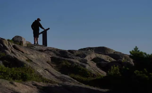 Visitors at the summit of Cadillac Mountain in Acadia National Park in Maine, on Saturday, July 11, 2026. (AP Photo/Jessie Wardarski)