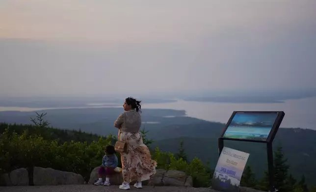 Visitors at the summit of Cadillac Mountain in Acadia National Park in Maine, on Tuesday, July 1, 2026. (AP Photo/Jessie Wardarski)