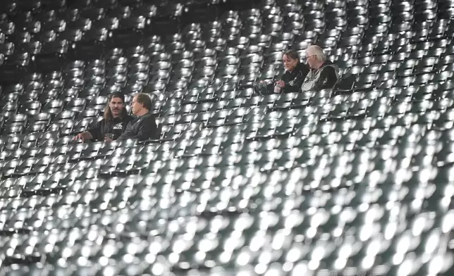 Chicago White Sox fans sit in seats after Game 4 of baseball's American League Division Series against the Cleveland Guardians, Thursday, Oct. 8, 2026, in Chicago. (AP Photo/Nam Huh)