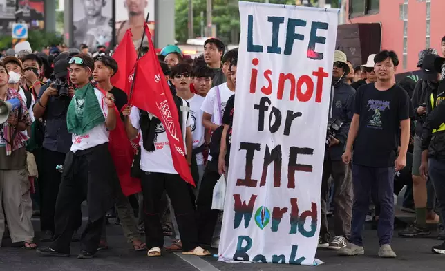 Protesters march to meeting venue during a demonstration against International Monetary Fund and the World Bank Group in Bangkok, Thailand, Thursday, Oct. 15, 2026. (AP Photo/Sakchai Lalit)