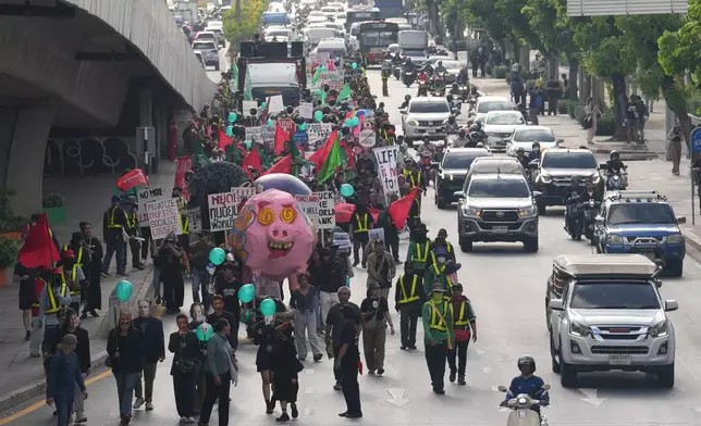 Protesters march to a meeting venue during a demonstration against International Monetary Fund and the World Bank Group in Bangkok, Thailand, Thursday, Oct. 15, 2026. (AP Photo/Sakchai Lalit)