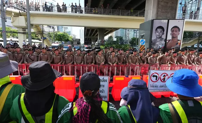 Protester stand near the meeting venue during a demonstration against International Monetary Fund and the World Bank Group in Bangkok, Thailand, Thursday, Oct. 15, 2026. (AP Photo/Sakchai Lalit)