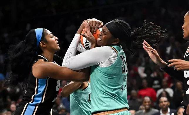Atlanta Dream forward Angel Reese (5) and New York Liberty center Jonquel Jones (35) fight for a rebound during the second half in Game 2 of the WNBA basketball semifinals, Wednesday, Oct. 7, 2026, in Atlanta. (AP Photo/Daniel Varnado)