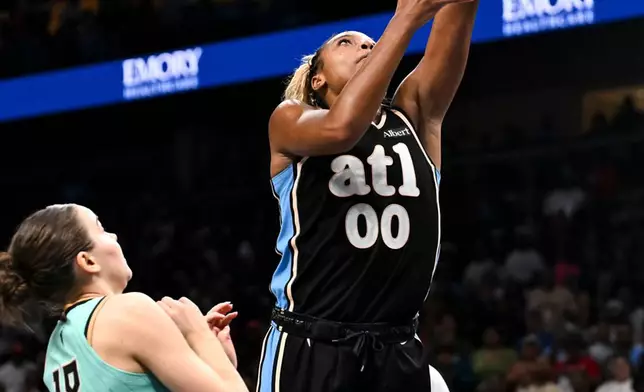 Atlanta Dream forward Naz Hillmon (00) makes basket against New York Liberty guard Pauline Astier (18) during the second half in Game 2 of the WNBA basketball semifinals, Wednesday, Oct. 7, 2026, in Atlanta. (AP Photo/Daniel Varnado)