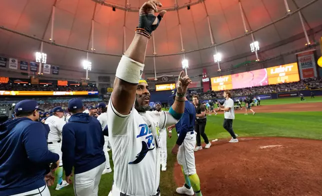 Tampa Bay Rays designated hitter Yandy Díaz celebrates their win against the Cleveland Guardians in Game 6 of an American League Championship Series baseball game in St. Petersburg, Fla. Monday, Oct. 19, 2026. (AP Photo/David J. Phillip)