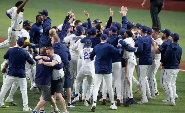 The Tampa Bay Rays celebrate their win against the Cleveland Guardians in Game 6 of an American League Championship Series baseball game in St. Petersburg, Fla. Monday, Oct. 19, 2026. (AP Photo/Chris O'Meara)