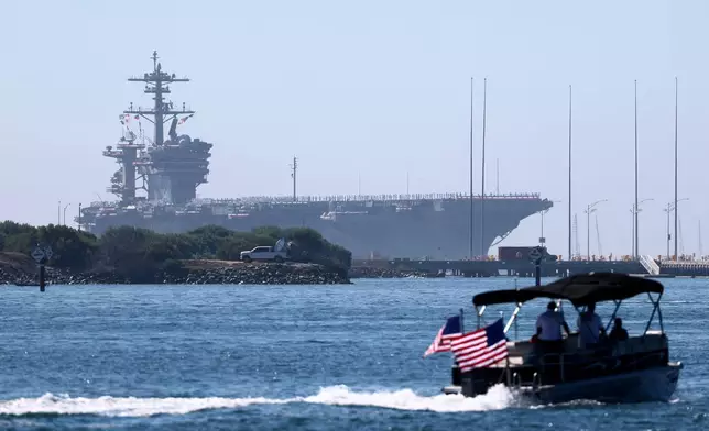 The USS Abraham Lincoln aircraft carrier returns to the San Diego Bay after deployment Thursday, Oct. 8, 2026, in San Diego. (AP Photo/Karl Anderson)