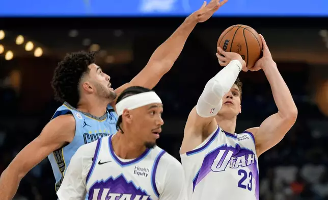 Utah Jazz forward/center Lauri Markkanen (23) shoots against guard Jahmai Mashack, left, in the first half of an NBA basketball game Wednesday, Oct. 21, 2026, in Memphis, Tenn. (AP Photo/Brandon Dill)