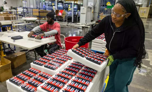 Paige McNair stacks lithium-ion battery modules inside Viridi's manufacturing plant in Buffalo, N.Y., Thursday, Oct. 15, 2026. (AP Photo/Lauren Petracca)