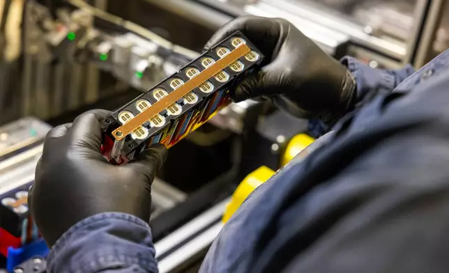 A worker checks over a lithium-ion battery module inside Viridi's battery system manufacturing plant in Buffalo, N.Y., Thursday, Oct. 15, 2026. (AP Photo/Lauren Petracca)