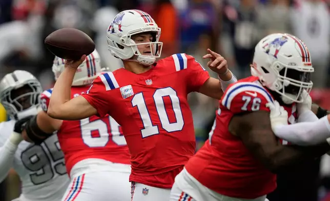 New England Patriots quarterback Drake Maye (10) looks to pass against the Las Vegas Raiders during an NFL football game in Foxborough, Mass., Sunday, Oct. 11, 2026. (AP Photo/Charles Krupa)