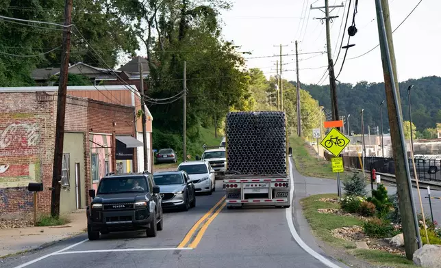 PVC pipe is transported on a truck from the IPEX factory that makes the pipe Thursday, Sept. 3, 2026, in Woodfin, N.C. (AP Photo/Allison Joyce)