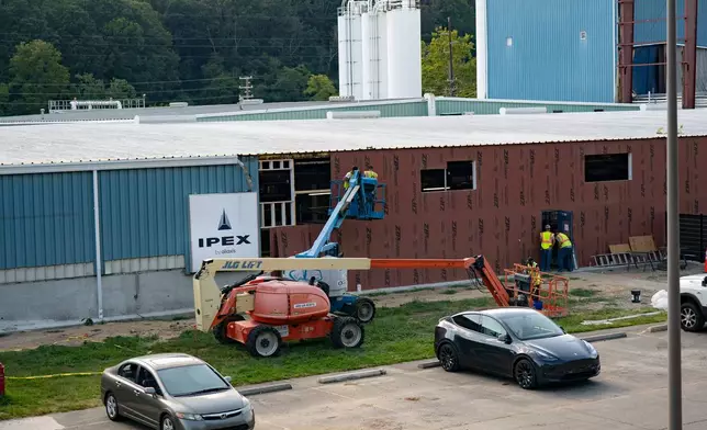 Construction work is done on the outside of the IPEX factory that makes PVC pipes Thursday, Sept. 3, 2026, in Woodfin, N.C. (AP Photo/Allison Joyce)