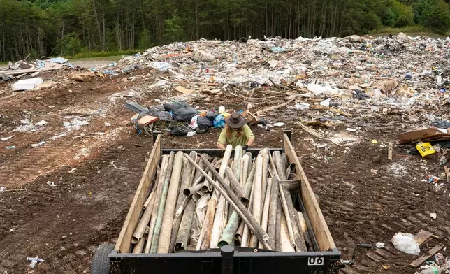 A worker from MountainTrue brings IPEX PVC pipe to the Buncombe County Landfill, Thursday, Sept. 24, 2026, in Alexander, N.C. (AP Photo/Allison Joyce)