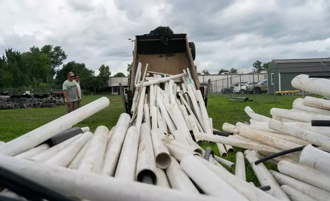 IPEX PVC pipe cleared from the riverbank is dumped at MountainTrue headquarters Wednesday, July 22, 2026, in Alexander, N.C. (AP Photo/Allison Joyce)